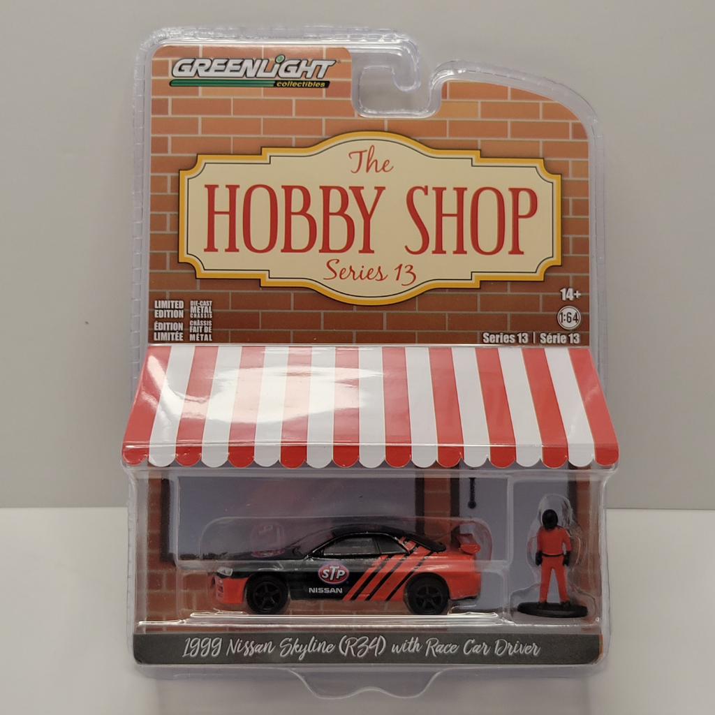 Greenlight - The Hobby Shop Series 13 - 1999 Nissan Skyline (R34) With Race Car Driver 1/64