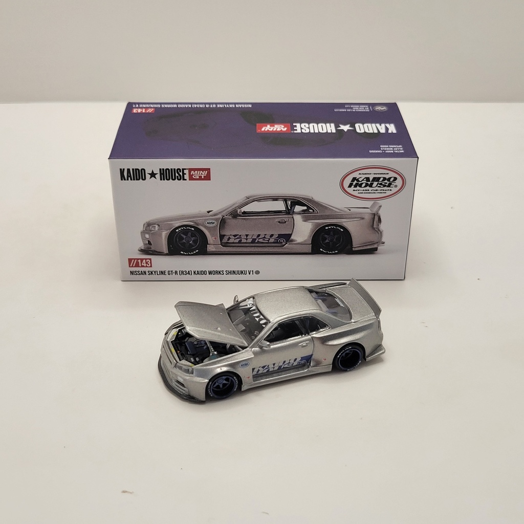 Kaido House Mini GT #143 - Nissan Skyline GT-R (R34) Kaido Works Shinjuku V1 1/64 (Scellé)